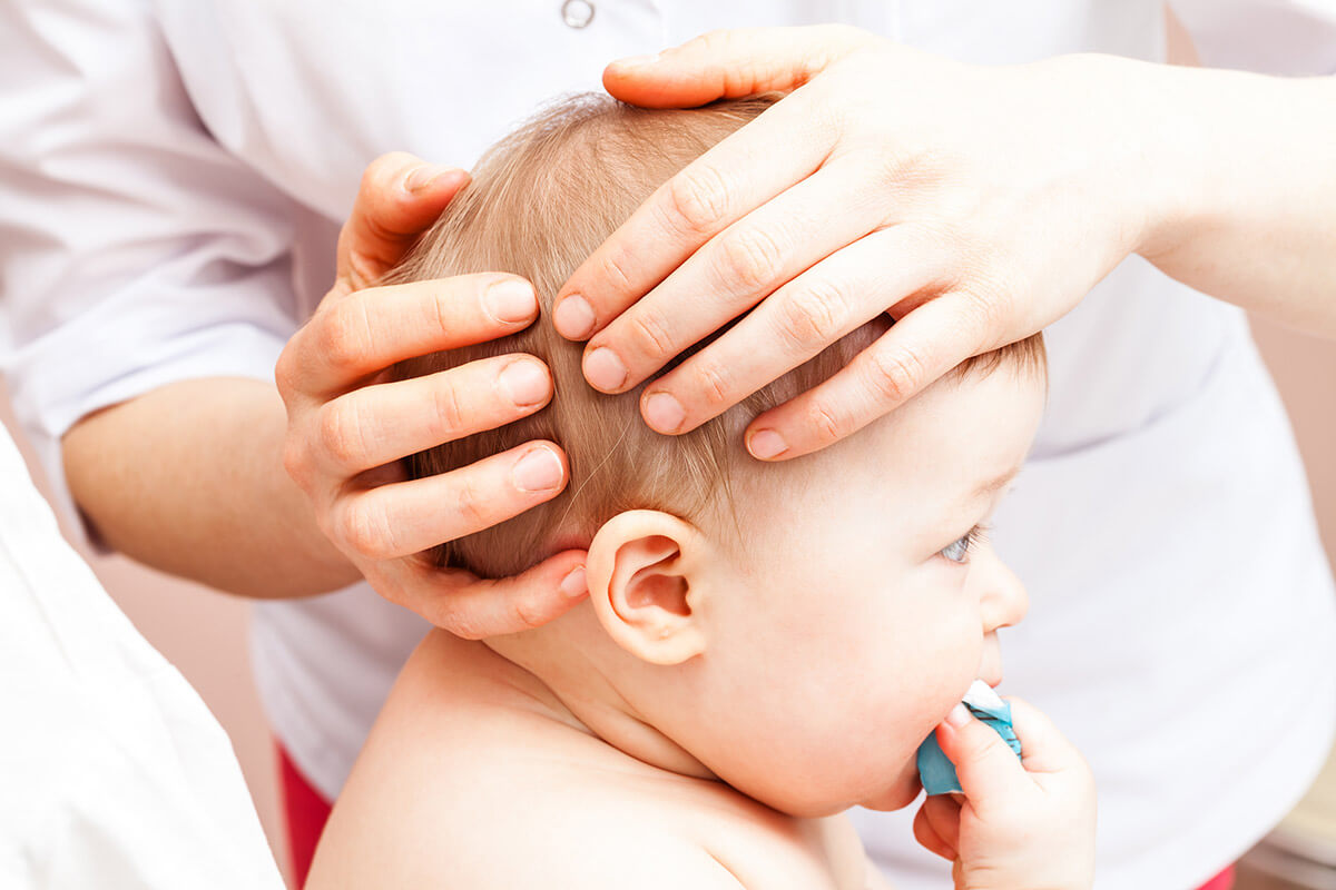 A certified pediatric chiropractor examining kid