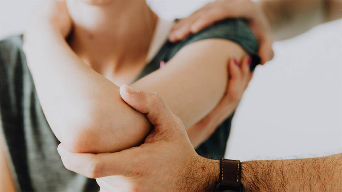 chiropractor working on a patient's arm